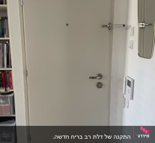 דלת לבנה עם ידית ומנעול כסוף